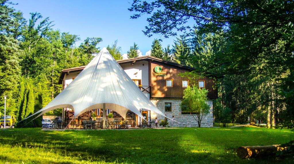 a large plastic pyramid in front of a house at Hotel Rakov Skocjan in Cerknica