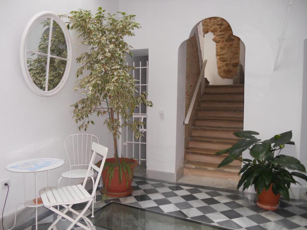 a room with two chairs and a table and stairs at Santa María 12 Boutique Apartamentos in Cádiz