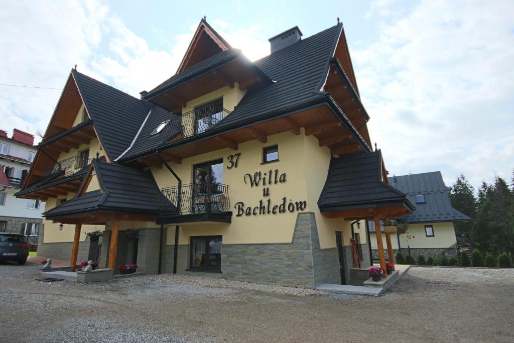 a large building with a black roof at Willa u Bachledów in Zakopane