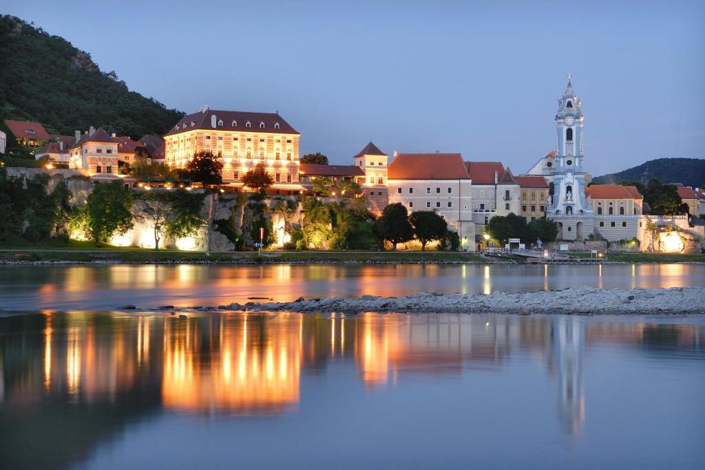 a view of a city at night at Hotel Schloss Dürnstein in Dürnstein