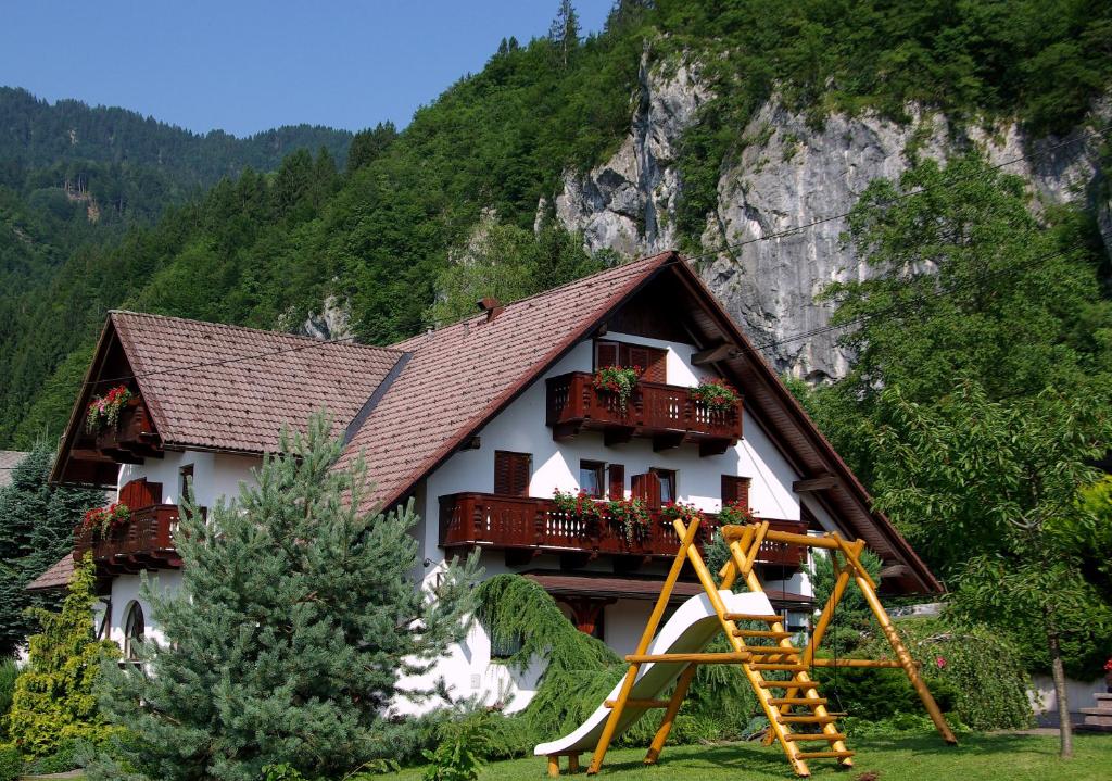 een huis met een balkon en een speeltuin bij Pr Bevc in Bled