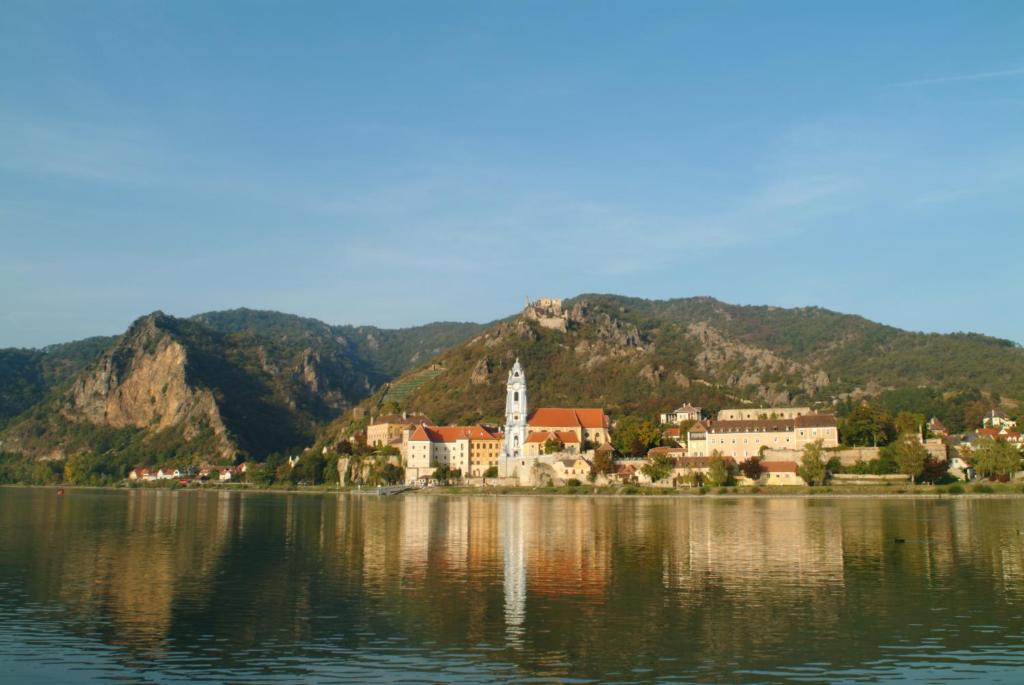 a small town on the shore of a body of water at Hotel Schloss Dürnstein in Dürnstein