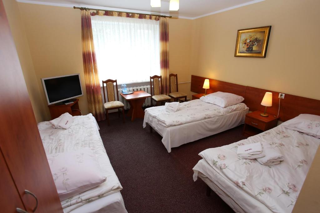 Posteľ alebo postele v izbe v ubytovaní Hotel Kakadu