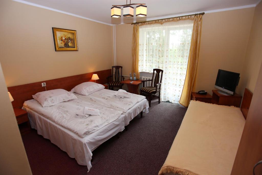 Posteľ alebo postele v izbe v ubytovaní Hotel Kakadu
