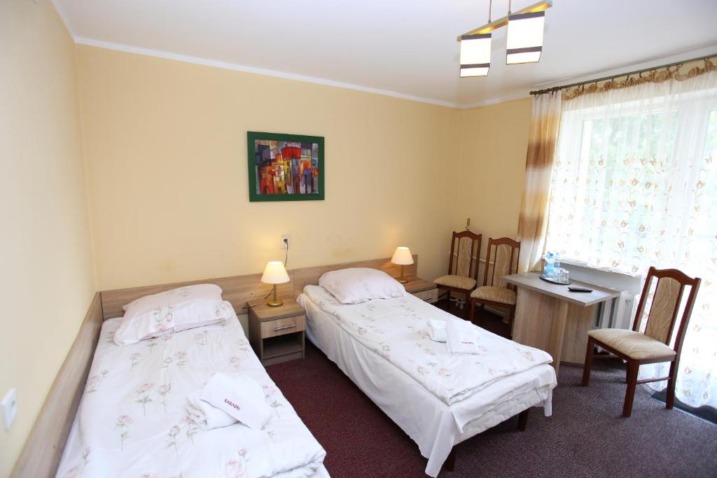 Posteľ alebo postele v izbe v ubytovaní Hotel Kakadu