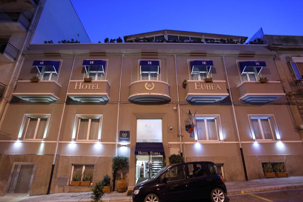 a car parked in front of a hotel at Hotel Eubea in Reggio Calabria