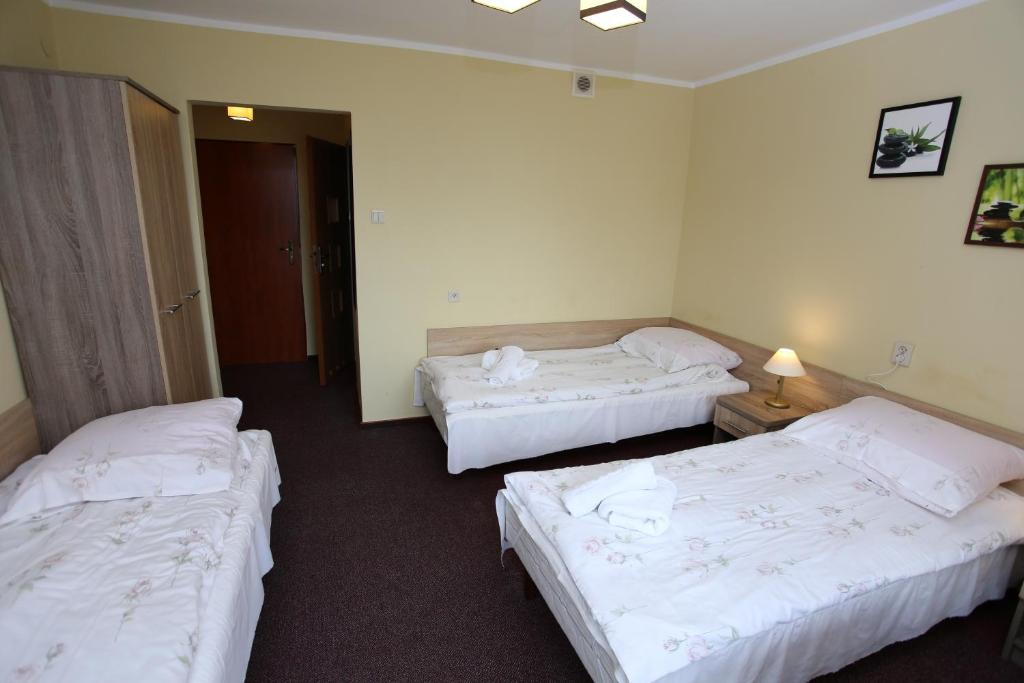 Posteľ alebo postele v izbe v ubytovaní Hotel Kakadu