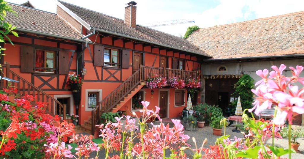 dom z kwiatami przed nim w obiekcie Chambres d'Hôtes Chez Mado Ottrott w mieście Ottrott