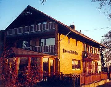 a large yellow building with a balcony on top of it at Landgasthof Gut Marienbildchen in Roetgen