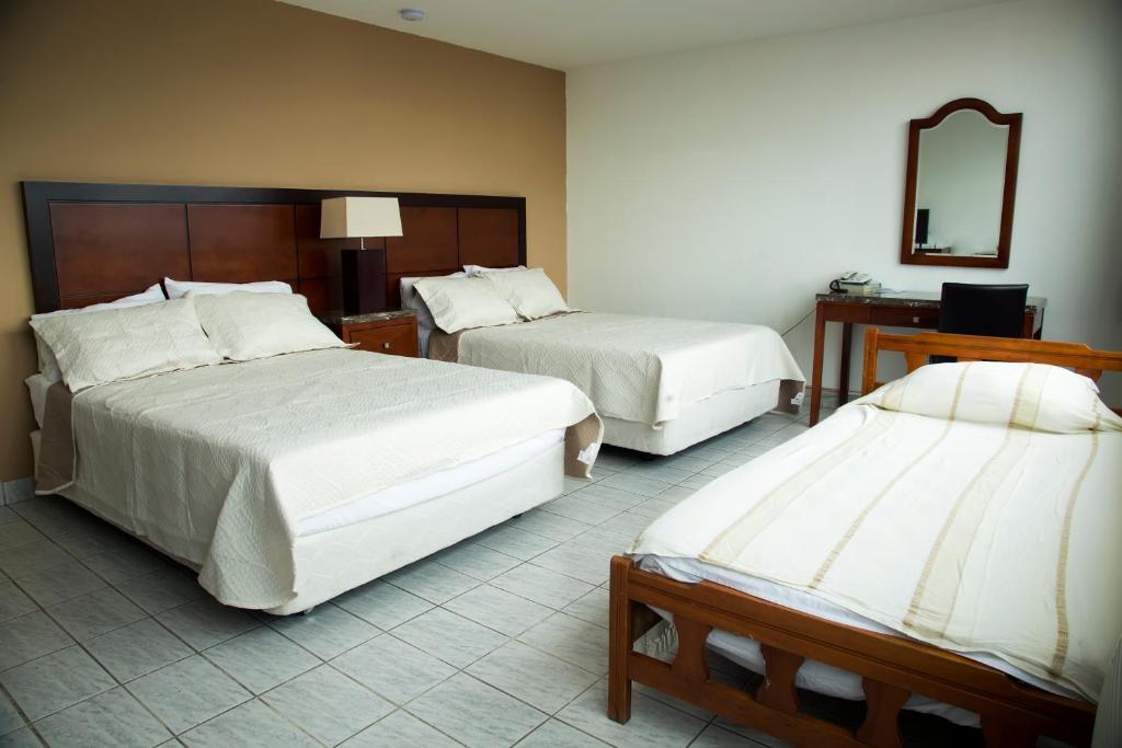 Postel nebo postele na pokoji v ubytování Hotel República Panamá