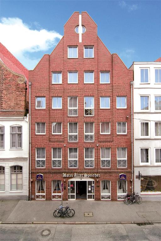 a large red brick building with a cross on it at Hotel Alter Speicher in Lübeck