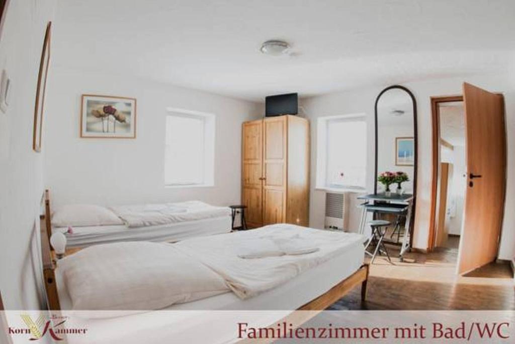 a bedroom with two beds and a mirror at Bauer Schmidt Weilerbach Bauer`s Budget-Hotel in Weilerbach