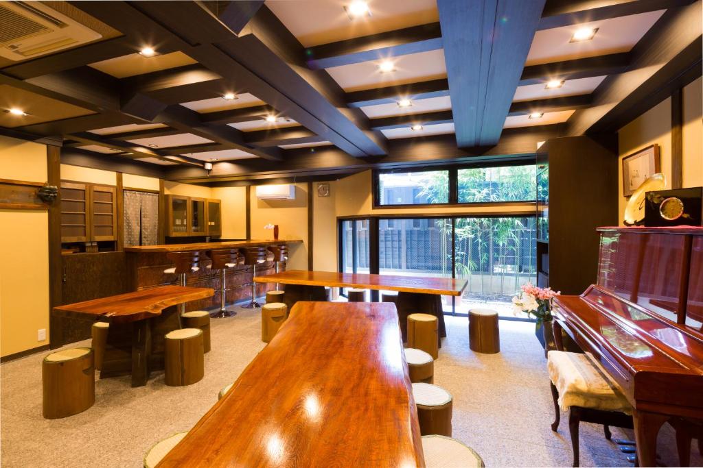 a restaurant with wooden tables and stools in a room at Matsubaya Ryokan in Kyoto