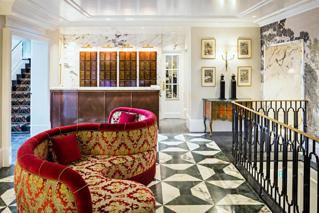 a living room with a chair and a counter at Relais Christine in Paris