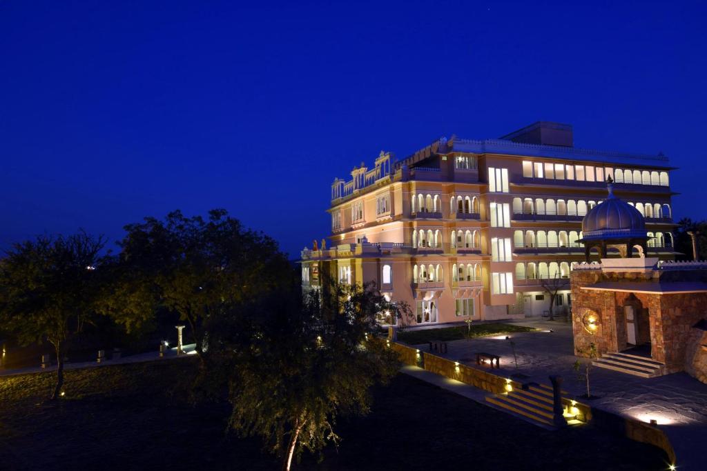 a building with a dome on top of it at night at Fateh Niwas by Fateh Collection in Udaipur
