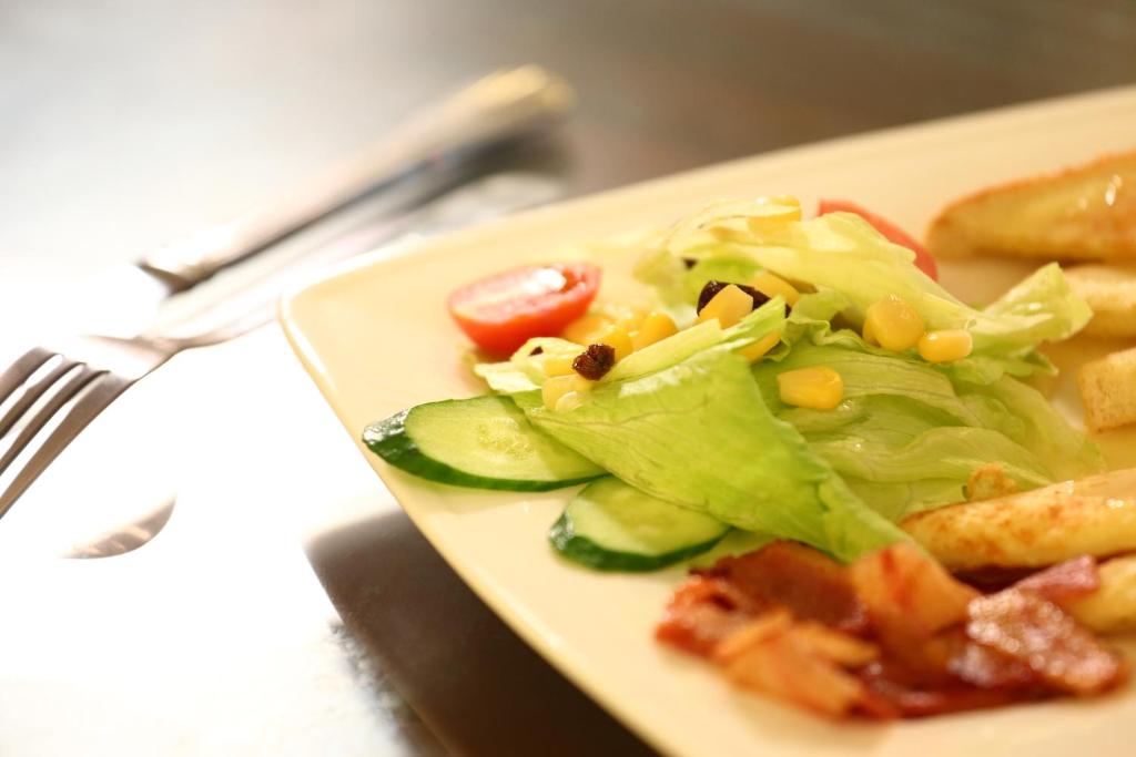 a plate of food with a salad and french fries at Love in Hualien B&amp;B in Hualien City