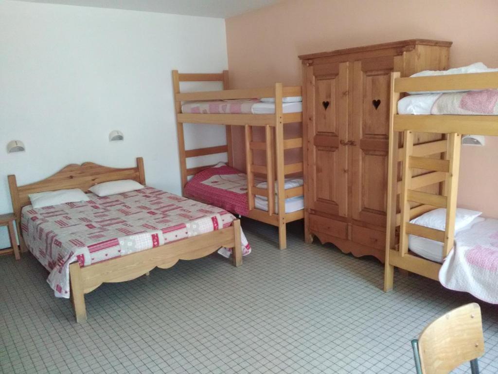 a room with two beds and two bunk beds at Cap Verb Guillestre in Guillestre