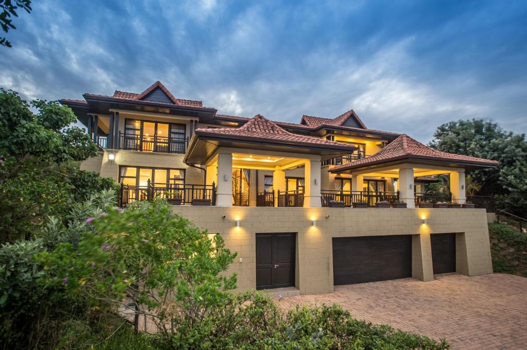 a large house with lights on top of it at Zimbali Holiday Home-22 Acaciawood in Ballito