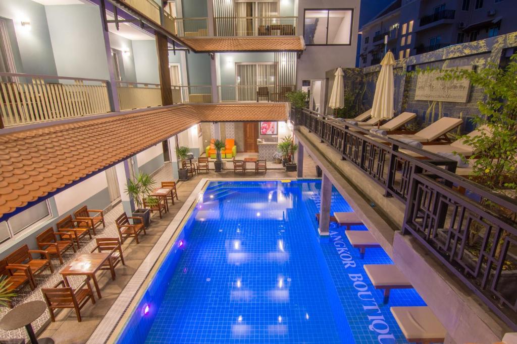 an overhead view of a hotel pool with tables and chairs at Chhay Long Angkor Boutique Hotel Siem Reap in Siem Reap