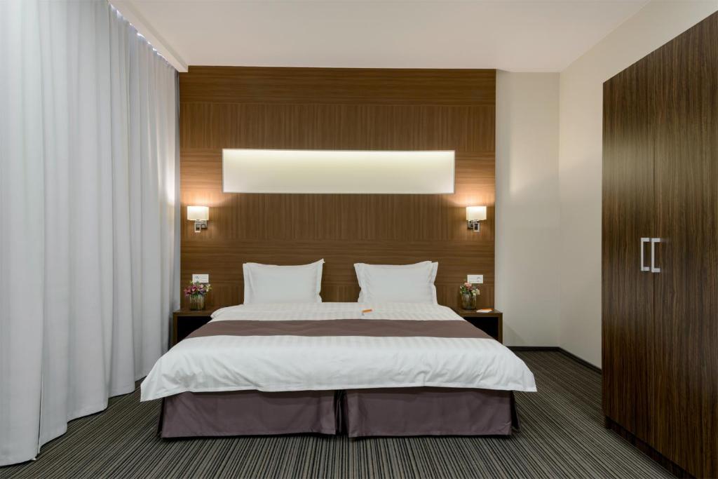 Postel nebo postele na pokoji v ubytování Park Wood Hotel - Academgorodok