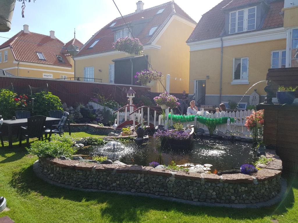 a garden with a pond in the yard at Ferie På Toppen in Skagen