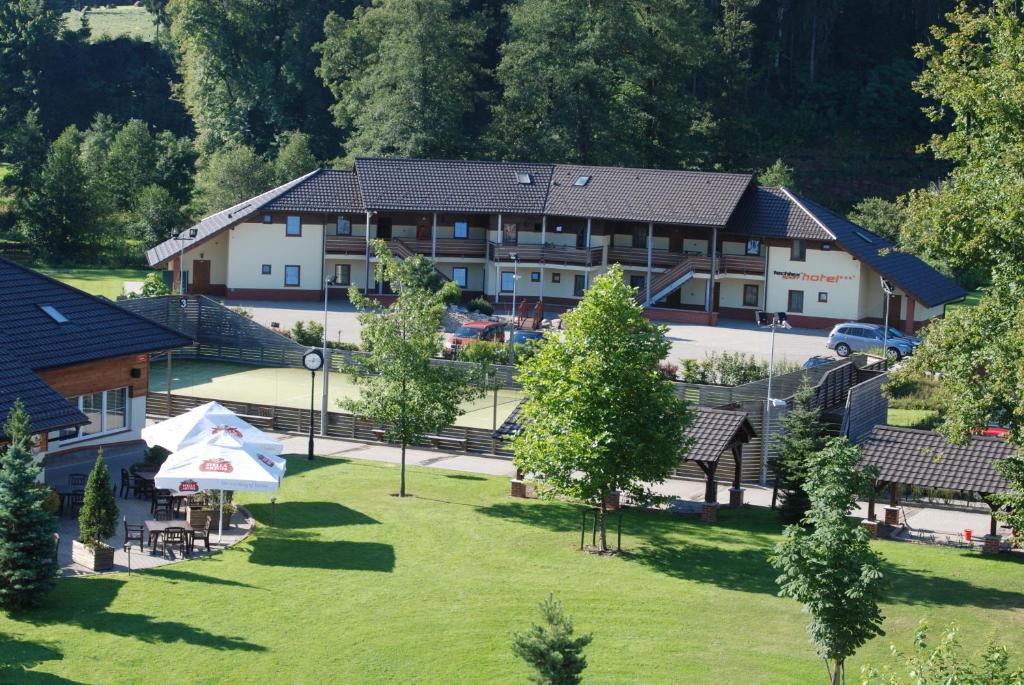 an aerial view of a hotel with a park at tx HOTEL in Hostinné