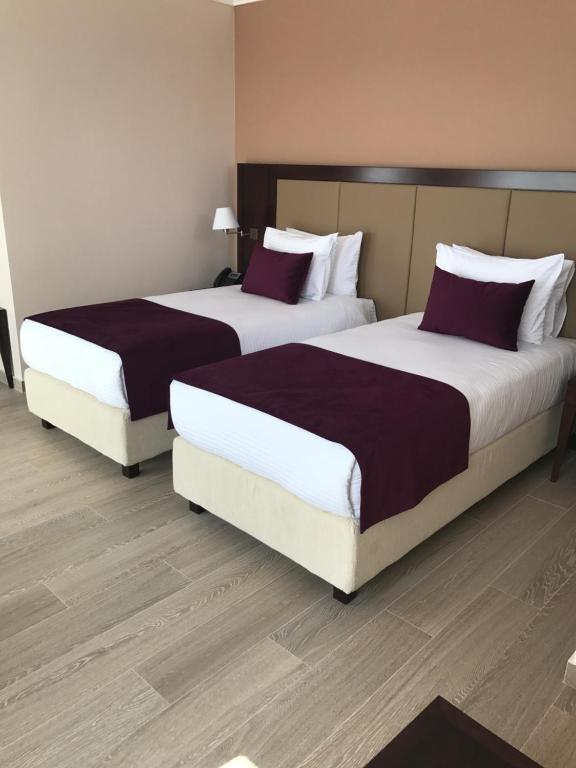 Postel nebo postele na pokoji v ubytování Xenon Hotel & SPA