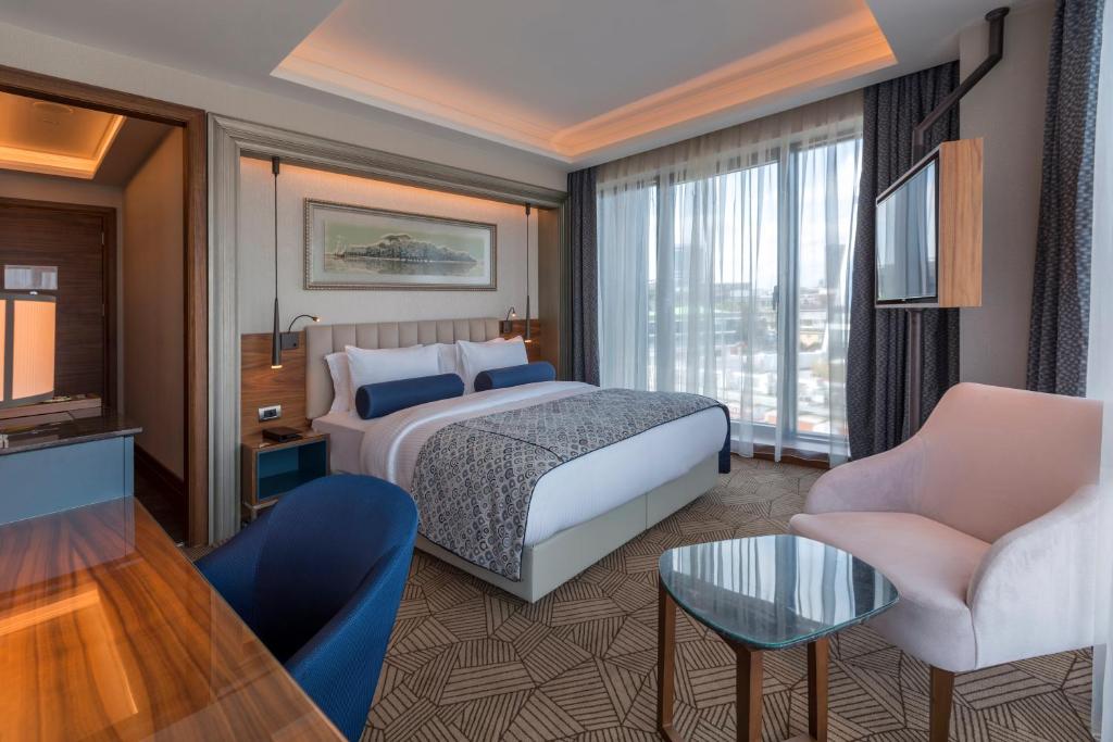 A bed or beds in a room at Golden Tulip Istanbul Bayrampasa
