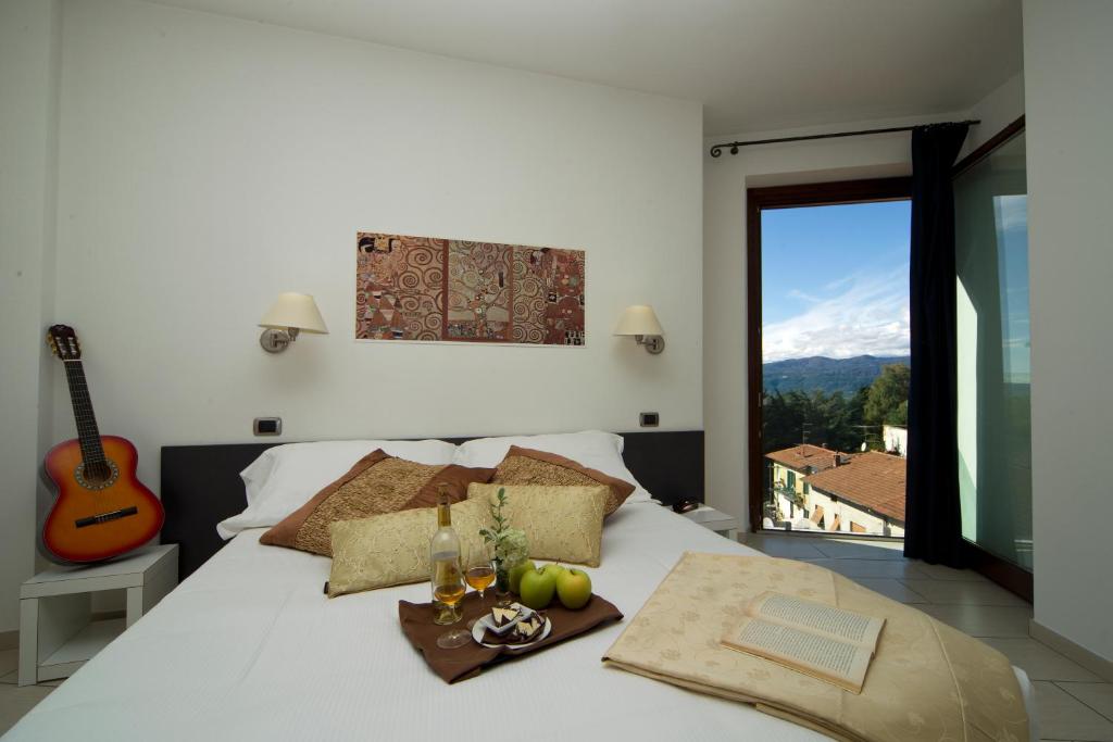 Postel nebo postele na pokoji v ubytování Hotel La Locanda