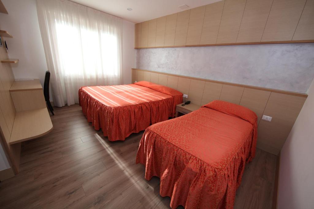 Postel nebo postele na pokoji v ubytování Al Benvenuto Hotel & Restaurant