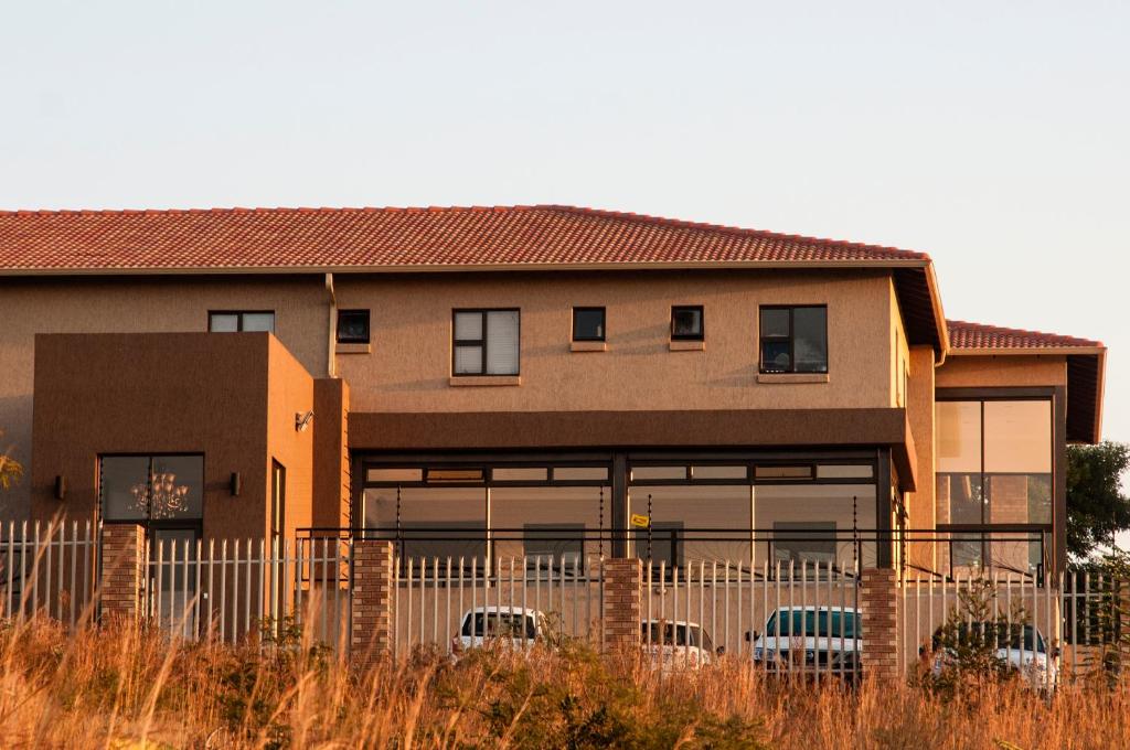 a building with cars parked in front of it at Eagle Nest Luxury Accommodation in Roodepoort