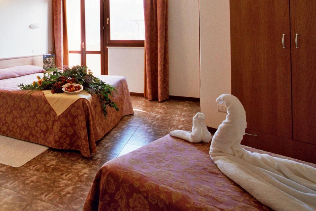 Postel nebo postele na pokoji v ubytování Hotel La Carica