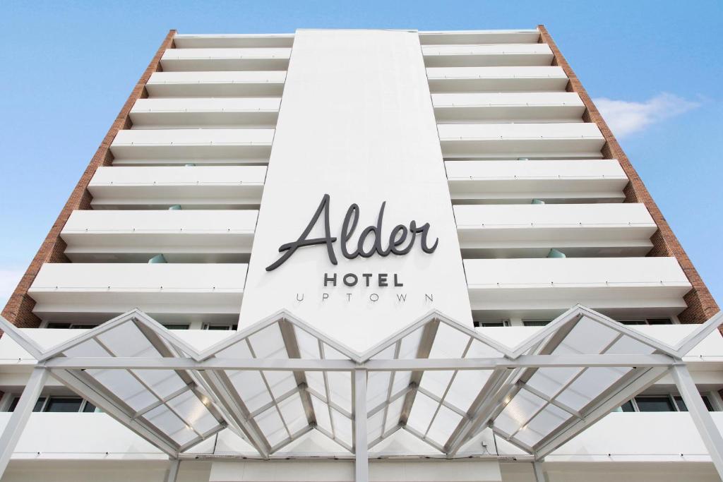 a building with a sign for an alergy hotel at Alder Hotel Uptown New Orleans in New Orleans