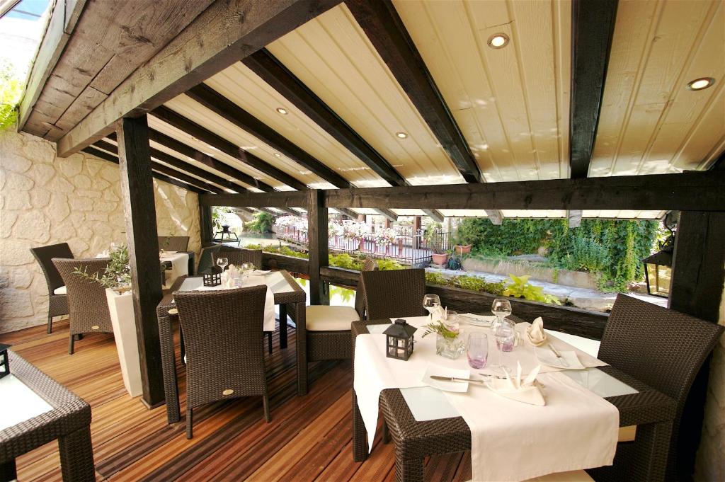 a restaurant with tables and chairs in a room at Hotel Restaurant Le Maréchal - Teritoria in Colmar