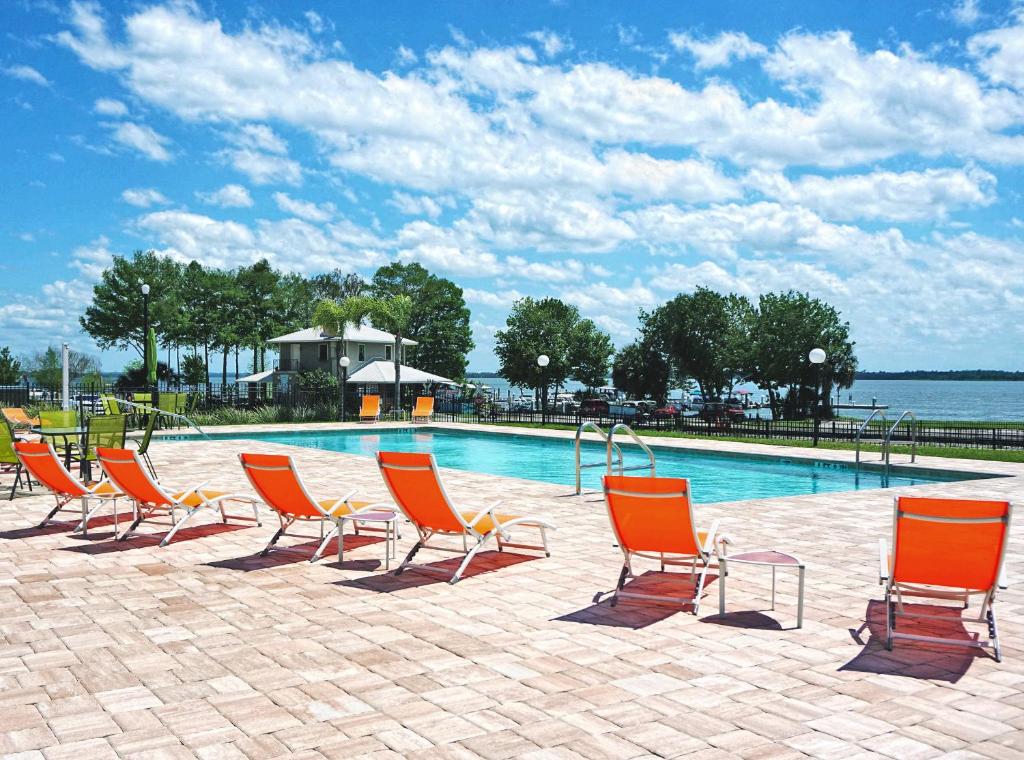 a group of chairs sitting next to a swimming pool at Key West Resort - Lake Dora in Tavares