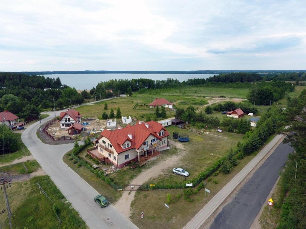 an aerial view of a large house with a road at Słoneczna Przystań in Kruklanki