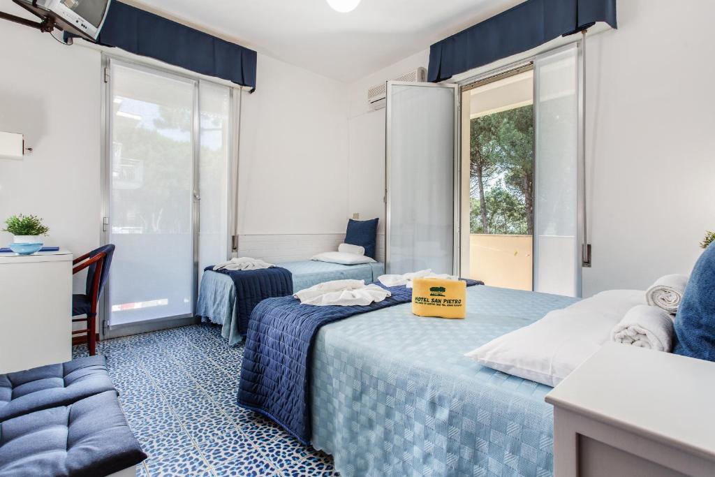 Postel nebo postele na pokoji v ubytování Hotel San Pietro