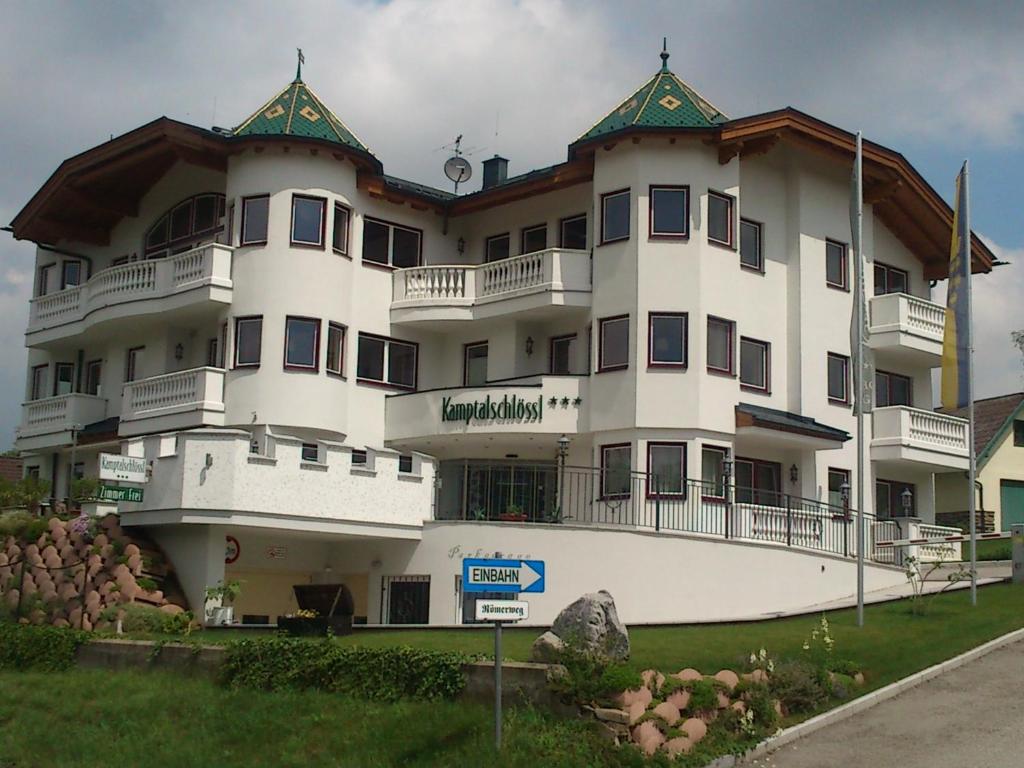 a large white building with a sign in front of it at Kamptalschlössl in Plank am Kamp