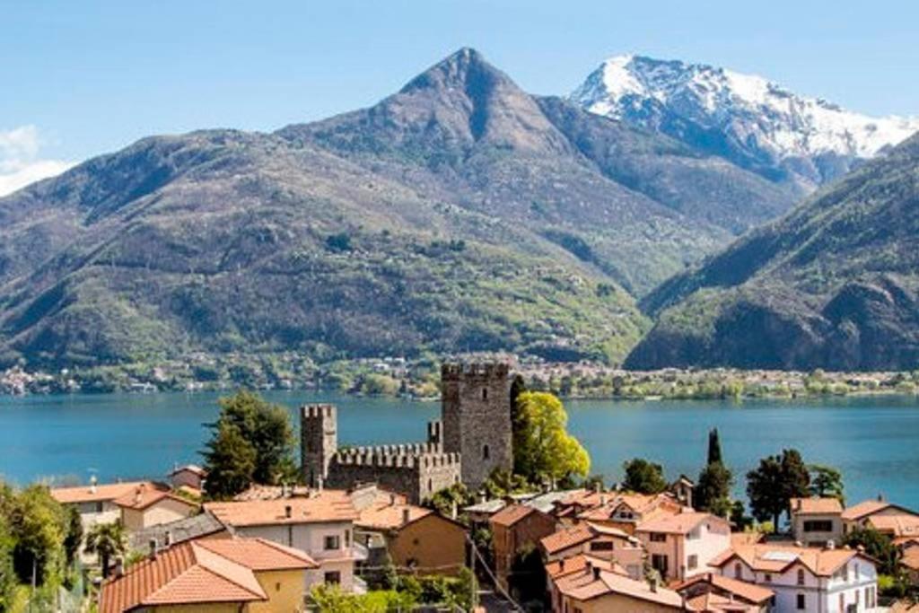 a town in front of a large body of water with mountains at Il Nido in Rezzonico