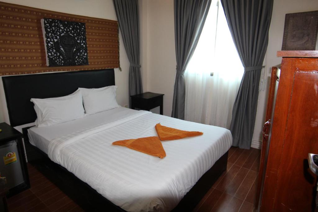 Postel nebo postele na pokoji v ubytování Naga Angkor Hostel
