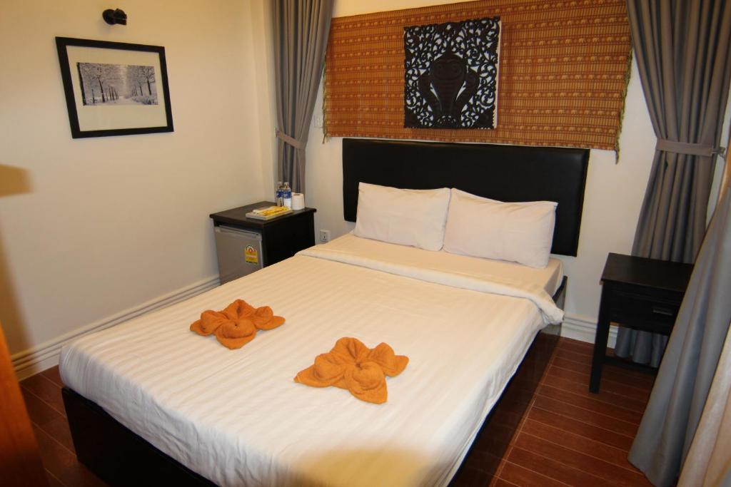 Postel nebo postele na pokoji v ubytování Naga Angkor Hostel