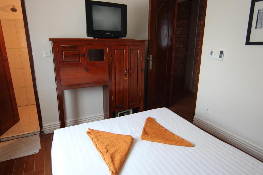 Postel nebo postele na pokoji v ubytování Naga Angkor Hostel