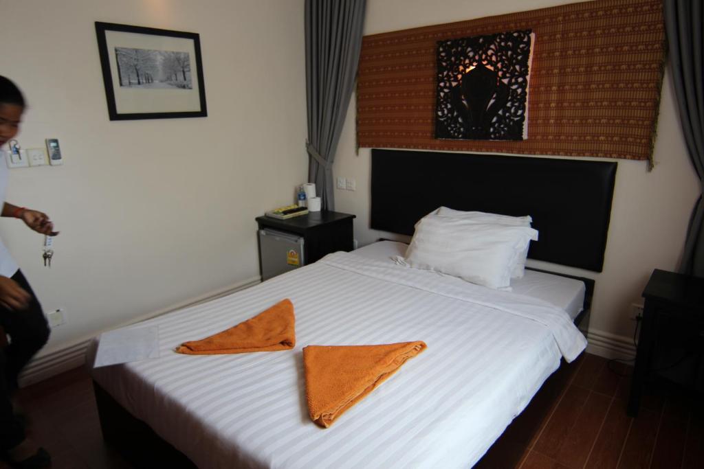 Postel nebo postele na pokoji v ubytování Naga Angkor Hostel