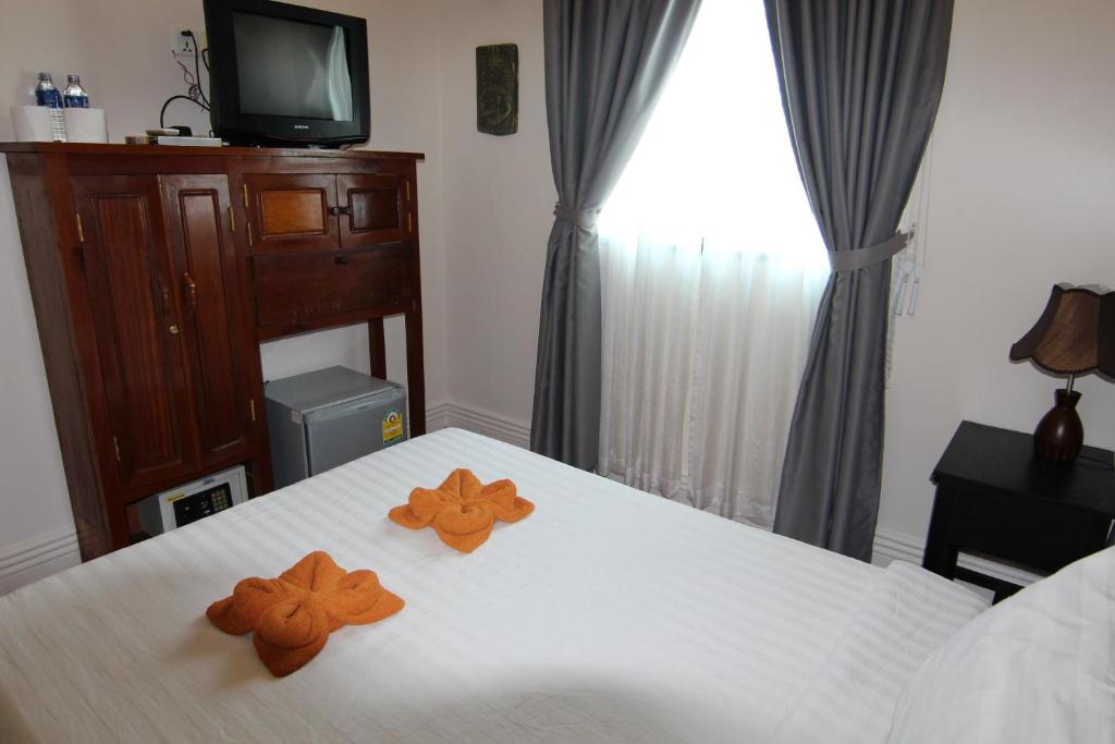 Postel nebo postele na pokoji v ubytování Naga Angkor Hostel