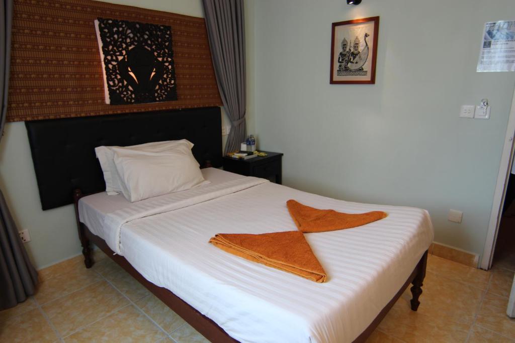 Postel nebo postele na pokoji v ubytování Naga Angkor Hostel