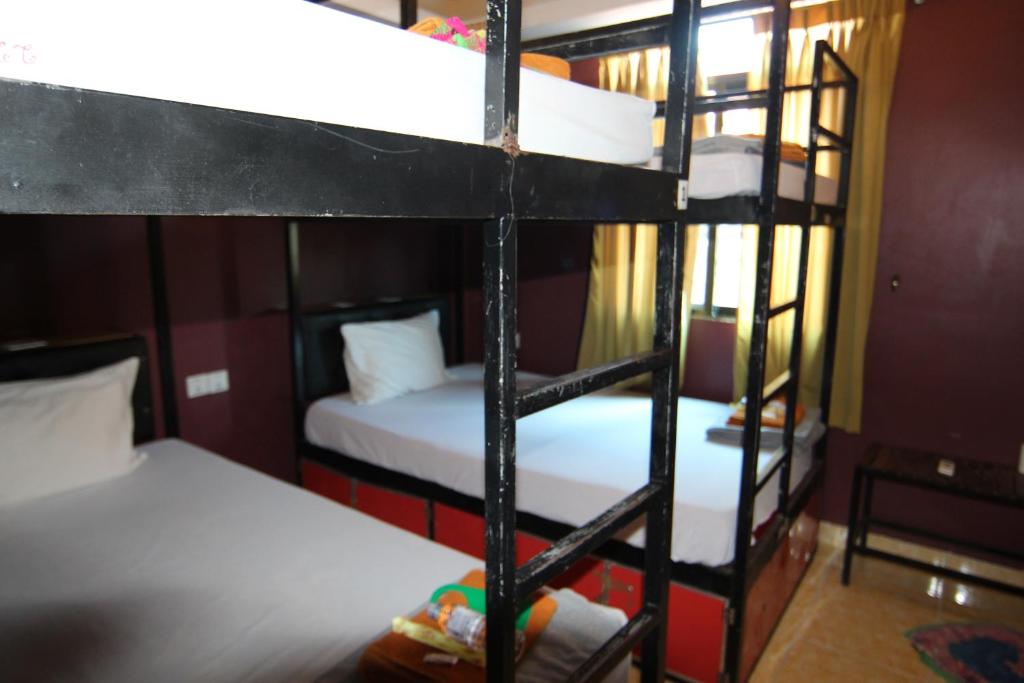Postel nebo postele na pokoji v ubytování Naga Angkor Hostel