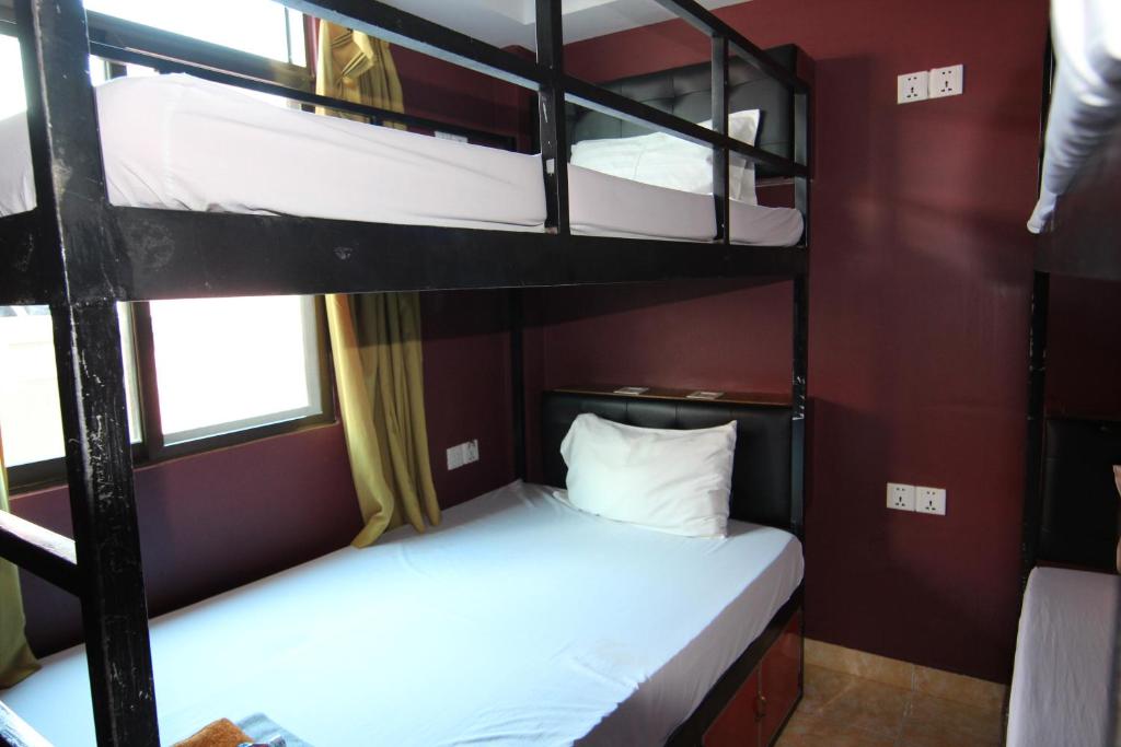 Postel nebo postele na pokoji v ubytování Naga Angkor Hostel