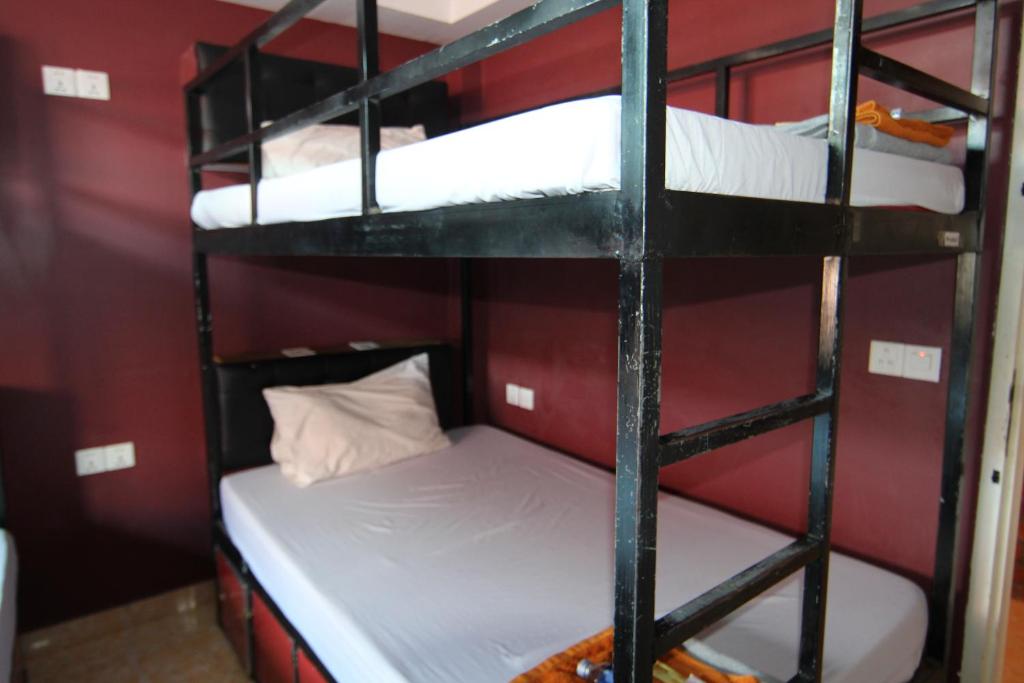 Postel nebo postele na pokoji v ubytování Naga Angkor Hostel