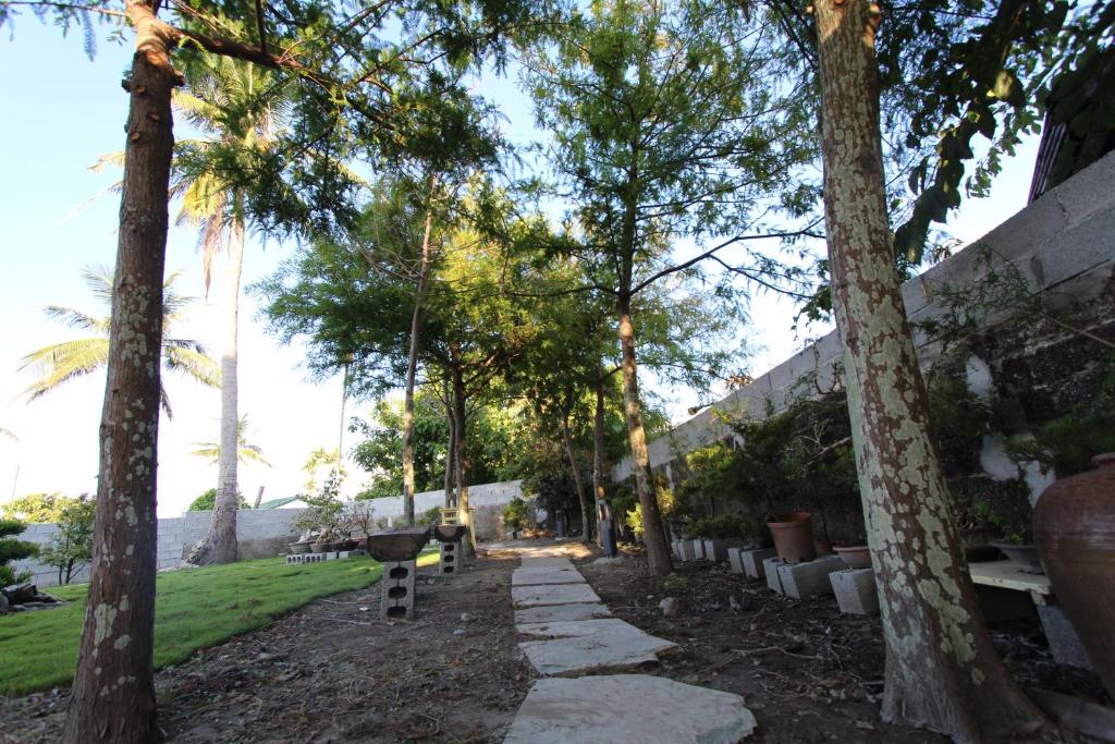 a walkway through a park with palm trees at Taitung Jia Lulan Tribal in Taitung City
