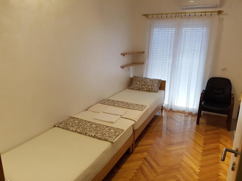 Postel nebo postele na pokoji v ubytování Apartmani Amaro